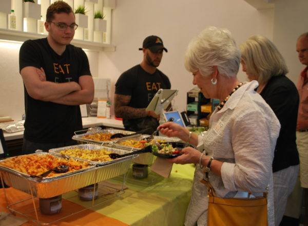 Attendees sample rescued food.