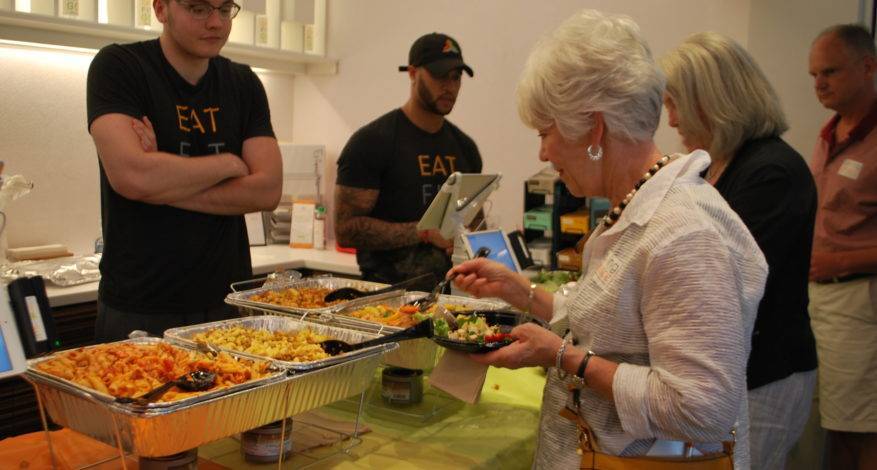 Attendees sample rescued food.